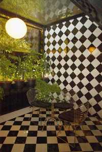 Pisos y paredes de diseño ajedrezado complementan la decoración del bar