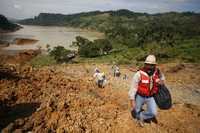 Trabajadores inspeccionan el desgajamiento de un cerro en de San Juan del Grijalva, ubicado en las márgenes del embalse de la presa Peñitas, en Chiapas