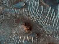 Imagen de la depresión Nili Fossae, tomada por el Orbitador de Reconocimiento de Marte. Las zonas verde y azulada representan áreas ricas en silicatos, como piroxeno y olivino. La parte rojiza está compuesta por magnesio y arcillas ricas en hierro, posiblemente formadas por agua al alterar rocas volcánicas