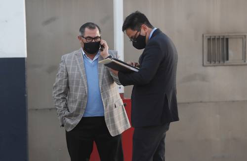 El abogado de Alonso Ancira, José Luis Castañeda (izquierda) , espera afuera del hangar de la FGR la llegada de su cliente. La defensa aseguró que podría enfrentar su proceso en libertad, ya que los delitos que se le imputan no están tipificados como graves.