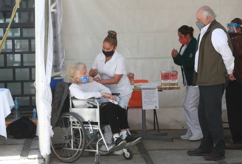 Adultos mayores formados para recibir la vacuna contra el Covid-19 en el exterior de la clínica 22 del IMSS, en la alcaldía Magdalena Contreras.