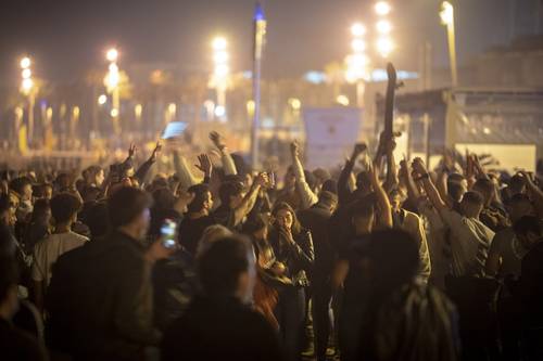 En Barcelona, ayer a media noche al terminar el estado nacional de emergencia que duró seis meses, la gente se reunió en la playa para cantar y bailar.