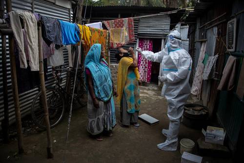 MASIVAS TOMAS DE MUESTRA EN LA INDIA. En un intento por contener la epidemia, trabajadores de salud acuden a los barrios bajos para detectar casos activos. La imagen, en el oriental estado de Assam.