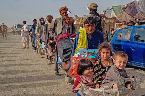 Familias enteras hacen fila en el puesto fronterizo de la población paquistaní de Chaman, ayer, con la intención de retornar a suelo afgano.
