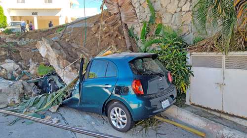 El sismo de magnitud 7.1 ocurrido la noche del martes, con epicentro a 11 kilometros de Acapulco, Guerrero, causó daños graves en algunos inmuebles del puerto. En la imagen, un vehículo aplastado por un alud de piedras y tierra.