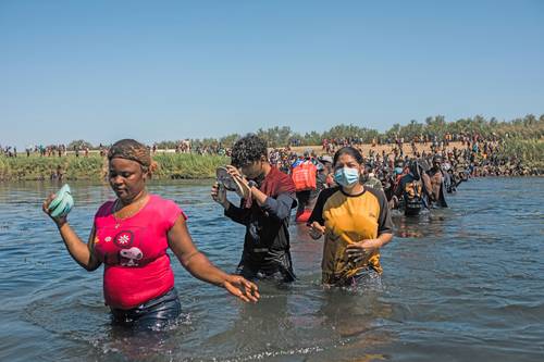 Migrantes cruzan el río Bravo desde Del Río, Texas, hasta Ciudad Acuña, Coahuila, para comprar alimentos y regresar al lado estadunidense de la frontera.