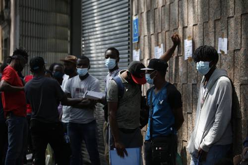 Haitianos esperan afuera de las instalaciones de la Comisión Mexicana de Ayuda a Refugiados (Comar) en la Ciudad de México para tramitar solicitudes de asilo, así como permisos de trabajo o de tránsito.