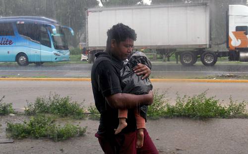 Con su niño en brazos, un solicitante de asilo avanza en la Caravana por la justicia, la dignidad y la libertad del pueblo migrante junto con cientos de personas procedentes de ocho países rumbo a la Ciudad de México en su camino hacia Estados Unidos.