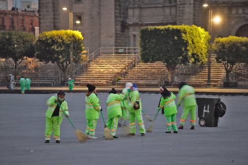 Trabajadores de limpia del Gobierno de la Ciudad de México realizan labores de limpieza en la Plaza de la Constitución tras las diferentes actividades que se realizaron el fin de semana, entre ellas el desfile por la Revolución Mexicana.