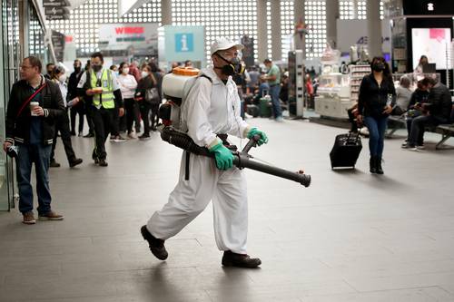 Ante el alza de infecciones, personal del aeropuerto de la CDMX limpia las instalaciones. Foto María Luisa Severiano