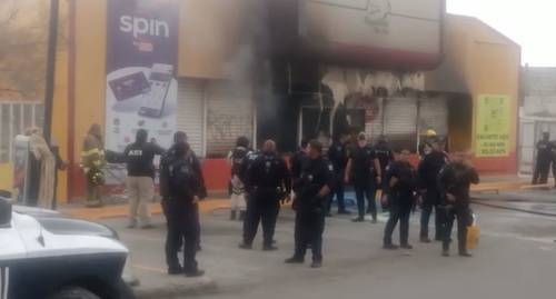 Elementos de la secretaría de seguridad pública municipal de Ciudad Juárez, Chihuahua, resguardan la tienda Rapiditos Bip-Bip, ubicada en la colonia Infonavit Juárez Nuevo, luego de que fue atacada con bombas molotov por presuntos integrantes del crimen organizado. En el lugar murió una mujer.