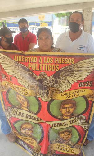 Norma Mesino Mesino, dirigente de la Organización Campesina de la Sierra del Sur, muestra una pancarta con las imágenes de Gerónimo Hernández, Orlando Ávila Mesino, Gilberto Aguirre Bahena y Antonio Barragán Carrasco, presos en cárceles de Guerrero y Morelos. La activista afirma que sus procesos legales están plagados de irregularidades.