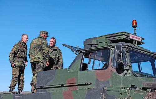 El ministro alemán de Defensa, Boris Pistorius (extremo derecho), y el teniente general Martin Schelleis, del ejército alemán (a la izquierda), captados sobre la base de un tanque Leopard 2 que sirve de escuela de manejo, en un área de entrenamiento militar en Mahlwinkel, cerca de Magdeburg, Alemania, hace unos días.