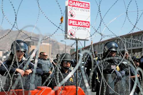 Agentes de Aduanas y Protección Fronteriza estadunidenses instalaron una barricada a la mitad del puente internacional para retener a la multitud en Ciudad Juárez, Chihuahua.