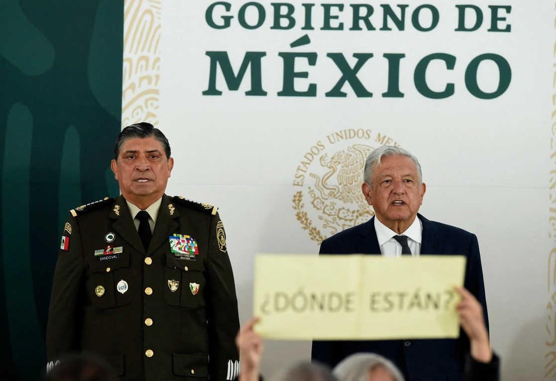 El presidente Andrés Manuel López Obrador encabezó ayer en el Campo Militar número uno la ceremonia oficial de apertura de archivos e instalaciones castrenses a la Comisión de la Verdad de la ‘guerra sucia’, acto al que definió como un hecho “doloroso, pero lleno de significado y esperanza”. En el encuentro, familiares de víctimas mostraron carteles con la leyendas: “¿Dónde están?” y “Si no entra la justicia, de nada sirve entrar”, durante el discurso del titular de la Sedena, Luis Cresencio Sandoval. Foto Afp 