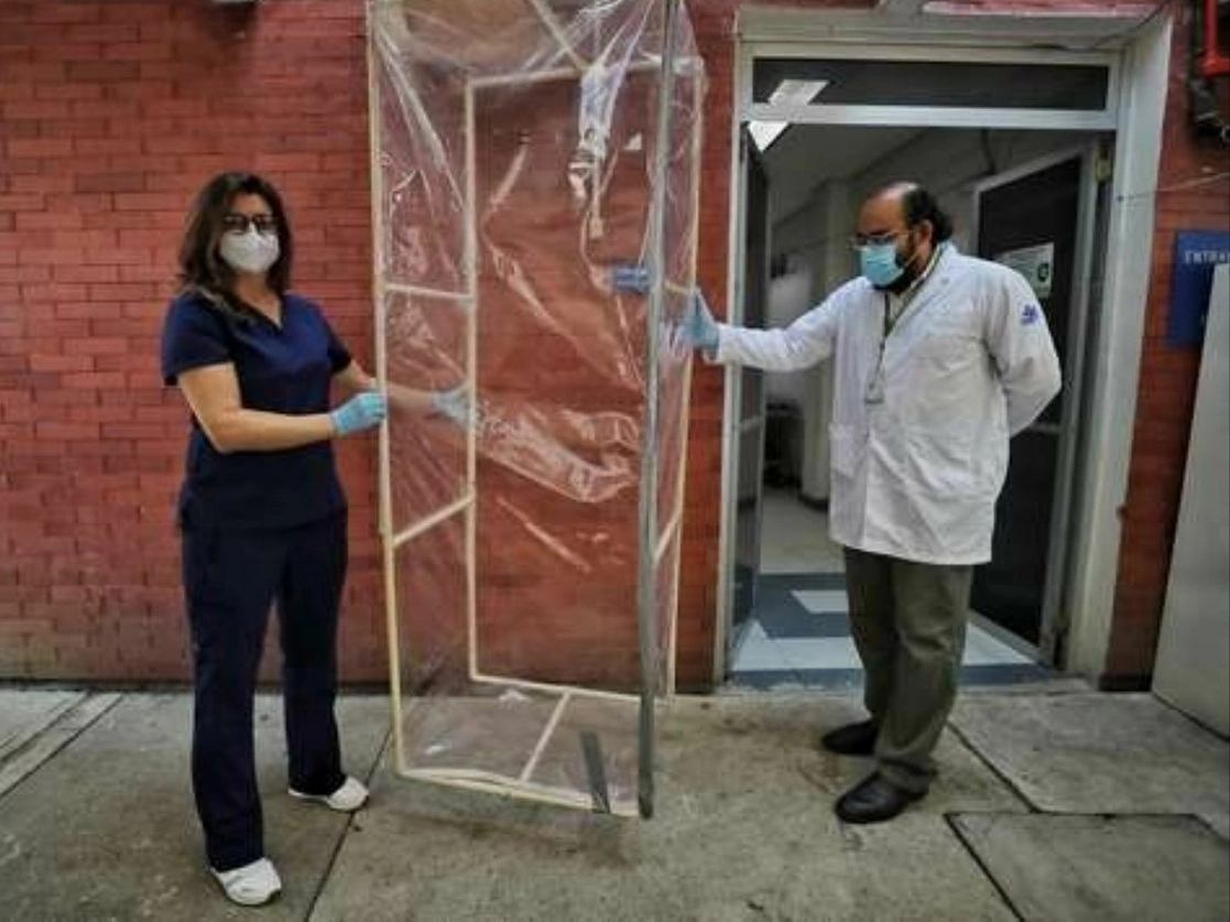 Los médicos Evelyn Rodríguez y César Luna muestran el prototipo de un domo diseñado para que los familiares de fallecidos por Covid-19 puedan ver el cadáver sin riesgo de contagio y eso les permita reconciliarse con su nueva realidad. Foto Marco Paláez