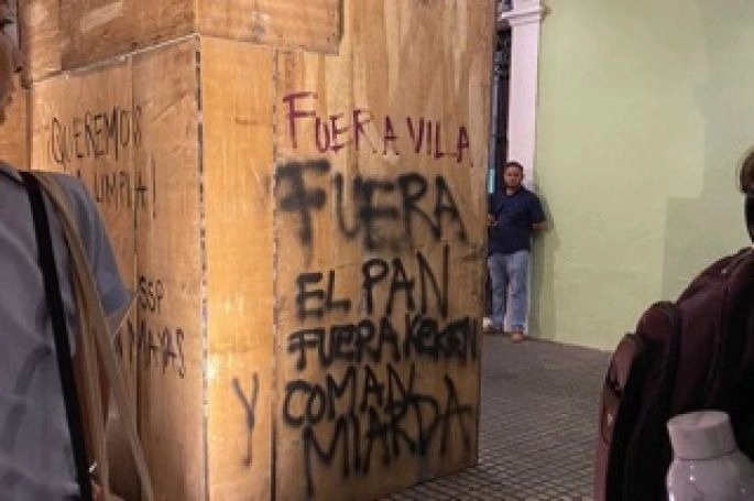 Un grupo de personas incurrió en actos de violencia y pintas a predios particulares y oficiales policíacos durante una marcha ciudadana por el Día del Agua en Mérida. Foto Luis Boffil