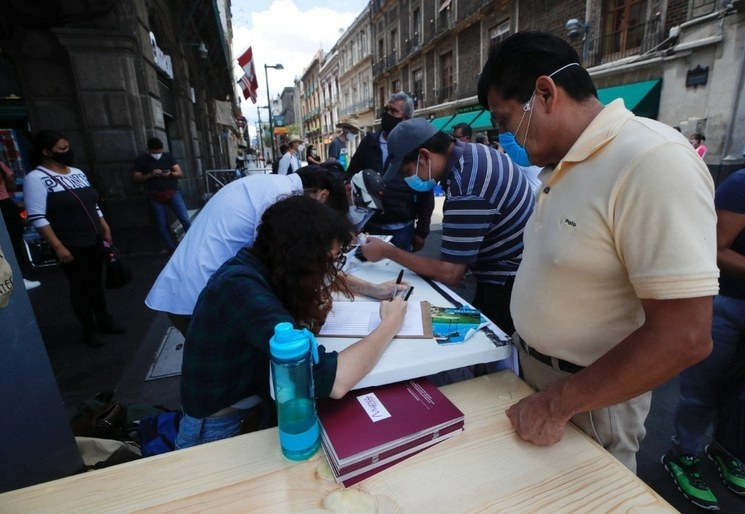 Activistas recaban firmas para promover una consulta sobre el posible enjuiciamiento a ex presidentes, en agosto pasado, en calles del Centro Histórico de la Ciudad de México. Foto Víctor Camacho 