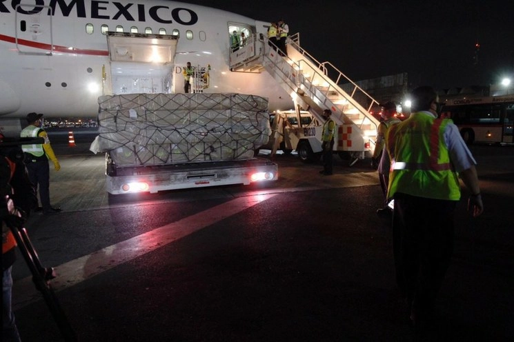 Personal de Aeroméxico durante la descarga de los insumos médicos. Foto Cristina Rodríguez