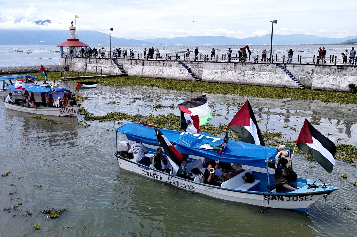 Integrantes del Comité de Solidaridad con Palestina se manifestaron ayer en botes en el lago de Chapala, Jalisco, en apoyo a la Global Sumud Flotilla, que se dirige con ayuda humanitaria a la franja de Gaza con miras a romper el cerco impuesto por Israel. Foto
