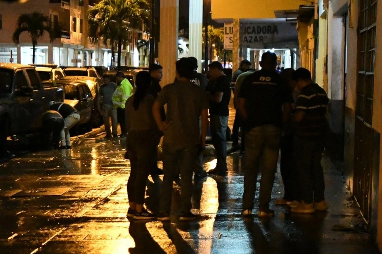 Policías ecuatorianos inspeccionan el lugar del homicidio múltiple en Guayaquil. Foto Afp 