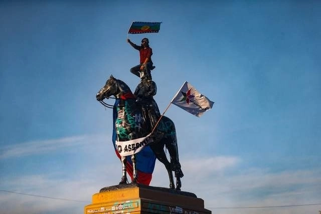 La bandera del pueblo mapuche es ondeada durante las manifestaciones sociales en Santiago, Chile. Foto Afp / Archivo