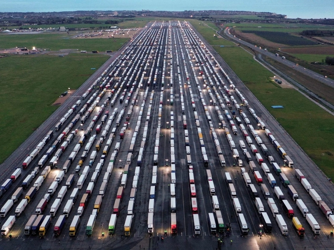 En una pista del aeropuerto de Manston, cerca de Dover, fueron estacionados infinidad de camiones de carga que no pudieron pasar a Francia y otros países europeos debido al cierre de fronteras ante la propagación de la nueva cepa del coronavirus en Gran Bretaña. Foto Afp