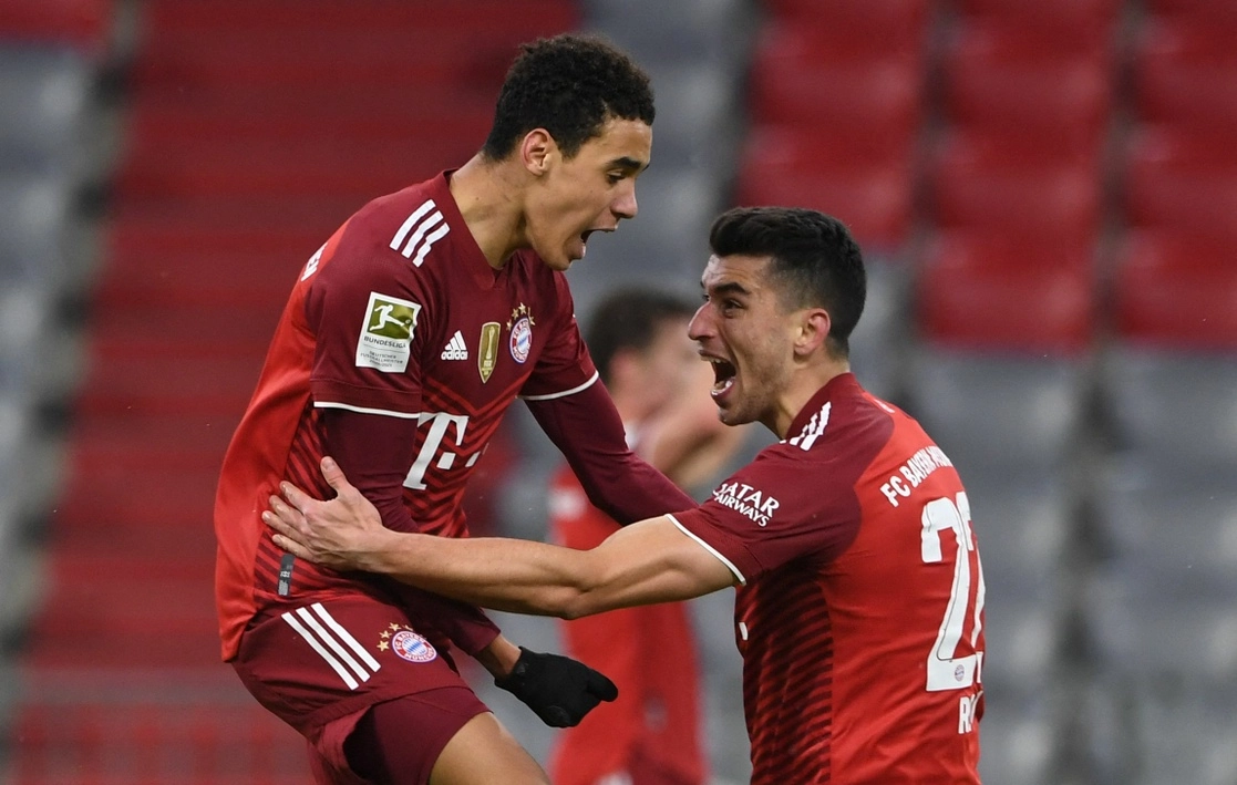 Jamal Musiala (izquierda) celebra con Marc Roca el gol que significó el 2-1 definitivo a favor del Bayern contra Mianz. Foto Afp
