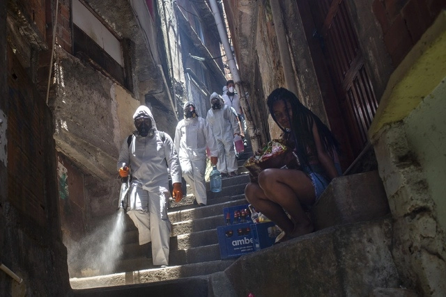 Voluntarios sanitizan con el objetivo de contener la propagación del Covid-19 en el barrio de Santa Marta, Río de Janeiro, Brasil. Foto Ap