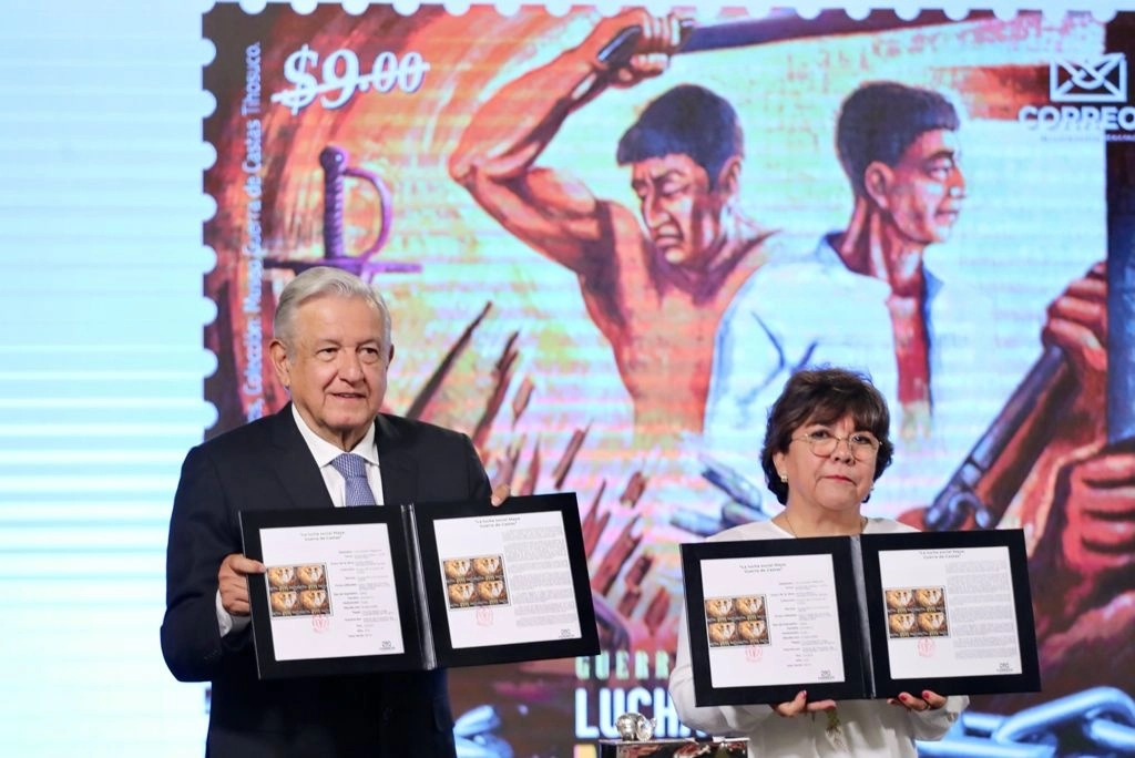 El presidente Andrés Manuel López Obrador cancela un sello postal durante su conferencia matutina en Palacio Nacional, en la Ciudad de México, el 4 de mayo de 2021. Foto Roberto García Ortiz