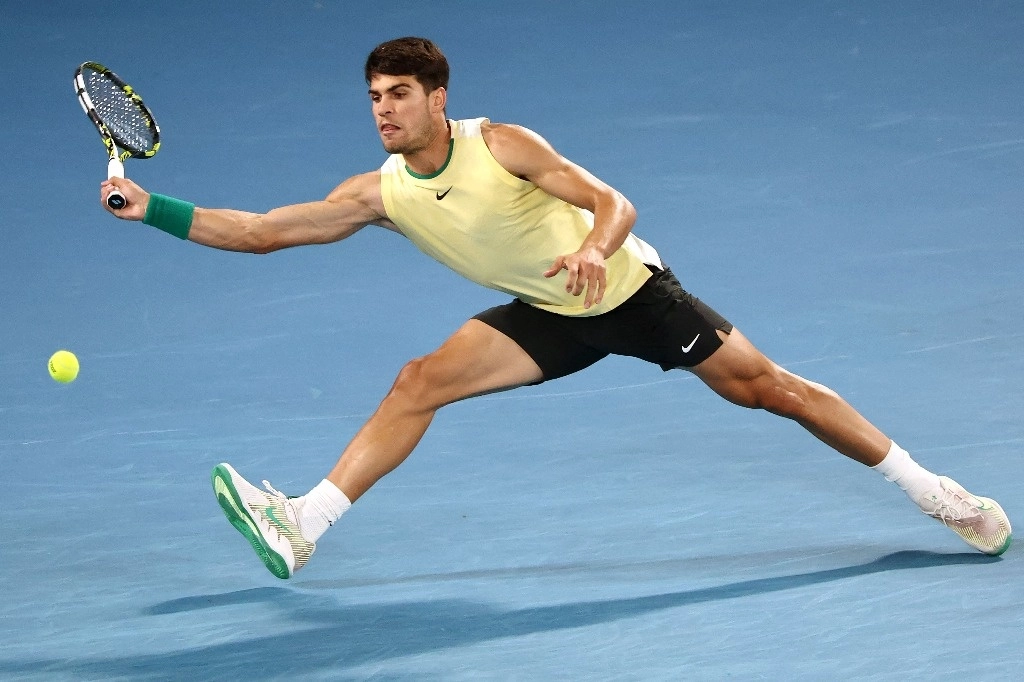 El español Carlos Alcaraz devuelve el balón al serbio Miomir Kecmanovic durante su partido individual masculino el noveno día del torneo de tenis Abierto de Australia en Melbourne, este 22 de enero de 2024. Foto AFP  