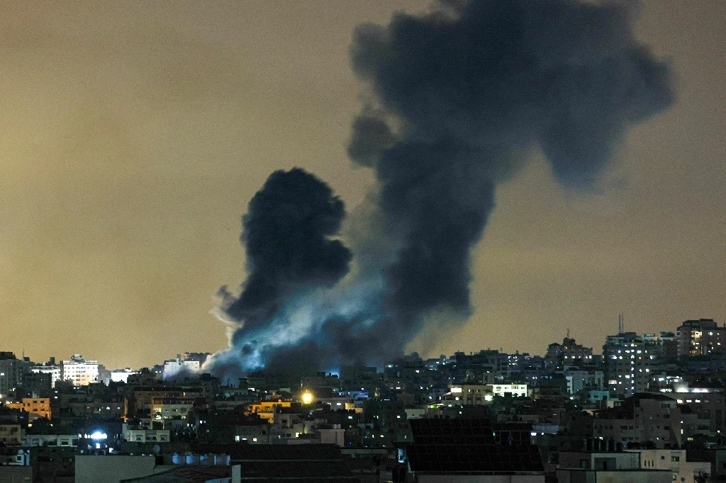 Una columna de humo se eleva sobre los edificios de la ciudad de Gaza durante un ataque aéreo israelí, el 8 de octubre de 2023. Foto AFP