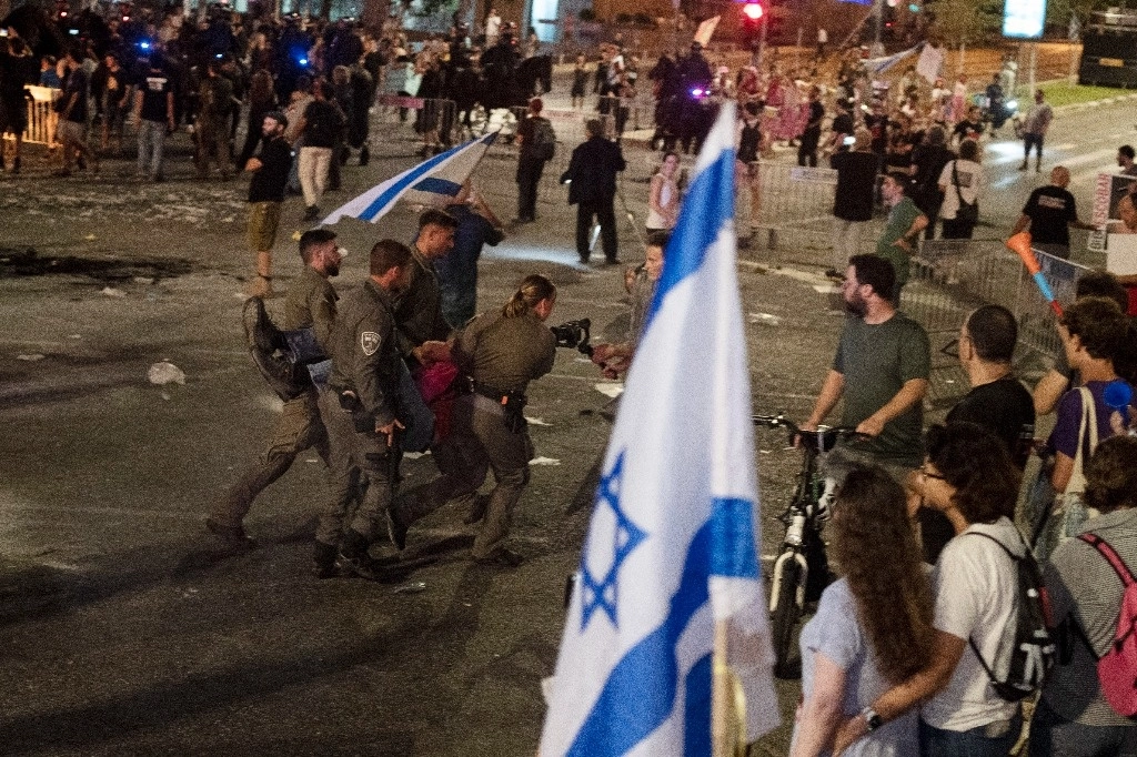 La policía israelí retira a un hombre que bloquea una carretera principal en una protesta contra el gobierno del primer ministro israelí, Benjamin Netanyahu. Foto Ap