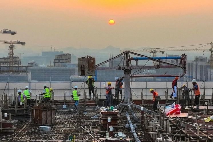 Trabajadores en un sitio de construcción de un proyecto de viviendas en Ningbo, en la provincia oriental china de Zhejiang. Foto Afp