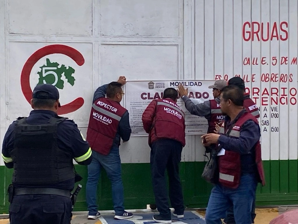 Personal del gobierno colocando los sellos de clausura. Foto Semov