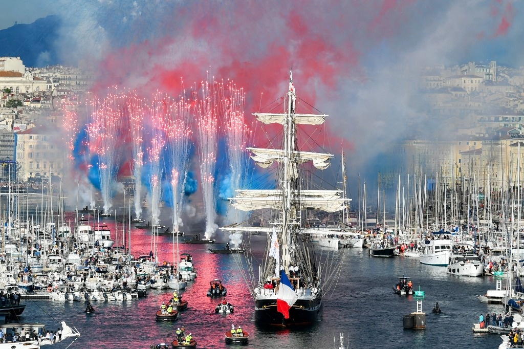 With great celebration, the Olympic flame lands in France