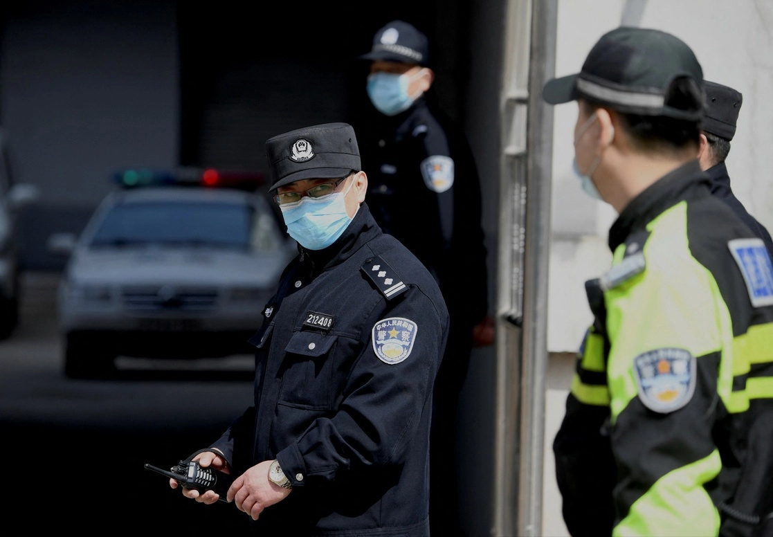 Policías vigilan el acceso a la corte de  Dandong, China, donde fue juegzado el empresario canadiense Michael Spavor y condenado por espionaje. La sentencia de 11 años fue conocida hoy. Foto Afp