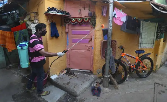 Un hombre desinfecta un área residencial en Mumbai, India. Foto Ap