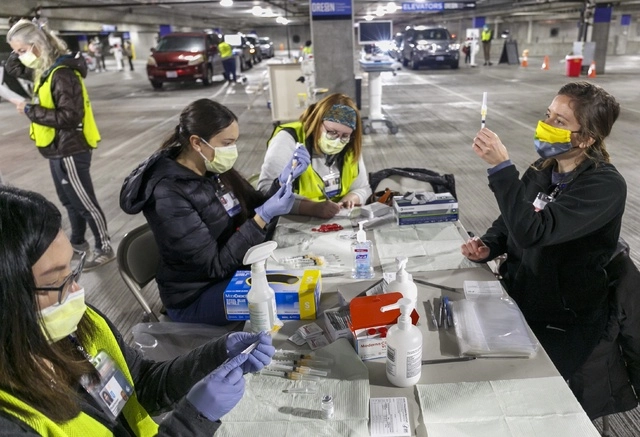 Médicos preparan dosis de la vacuna de coronavirus en una clínica en Portland, Estados Unidos. Foto Ap 
