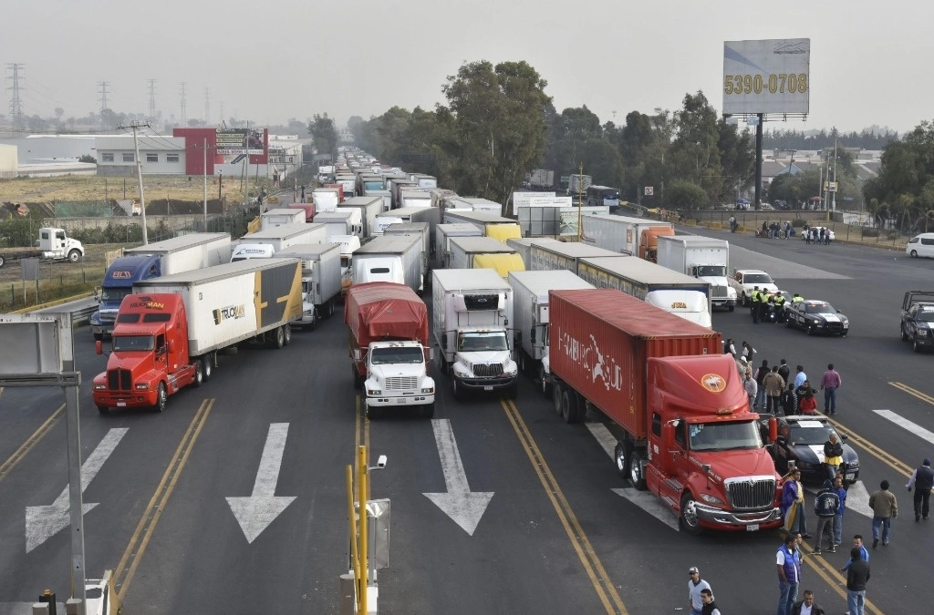 Con vehículos atravesados en la autopista México-Querétaro, dueños y trabajadores de peluquerías mexiquenses clausurados exigieron a la FGJEM el retiro de sellos de suspensión de actividades. Foto Cuartoscuro / Archivo
