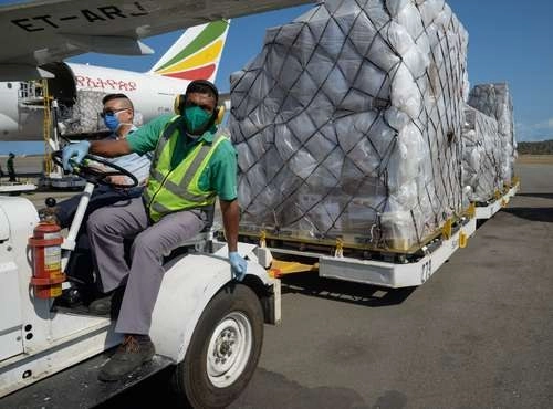Trabajadores descargan insumos sanitarios provenientes de China, en el Aeropuerto Internacional Simón Bolívar, en La Guaira, Venezuela. Foto Xinhua