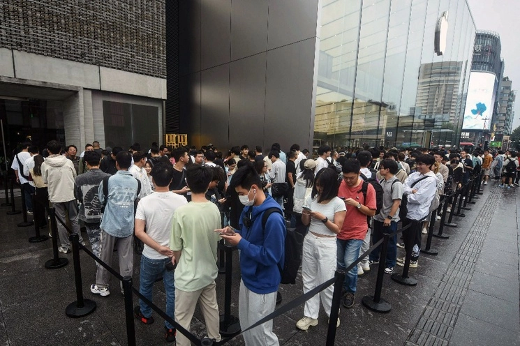 Fila para comprar el iPhone 15 en una tienda de Apple en Hangzhou, China. Foto Afp