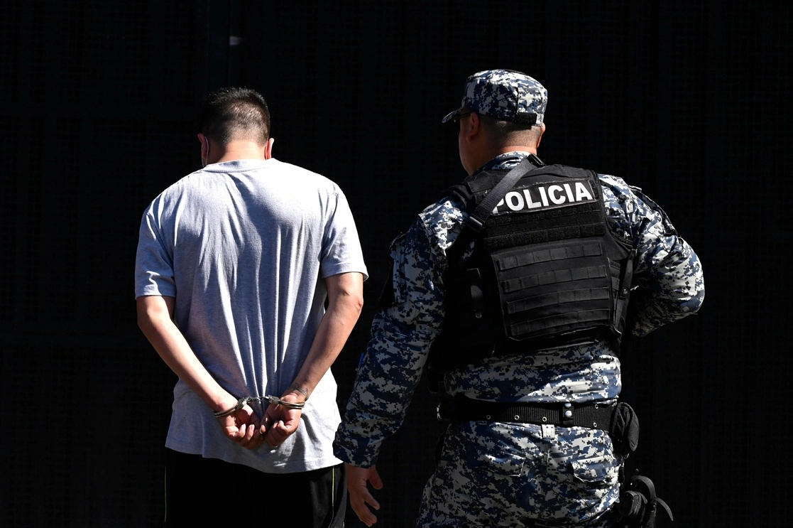 Elemento de la Policía Civil detiene a un presunto pandillero en El Salvador, el pasado 22 de junio. Foto Afp 