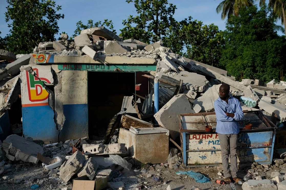 Un hombre junto a una tienda colapsada por el terremoto en Saint Louis du Sud, Haití, el 16 de agosto de 2021. Foto Ap 