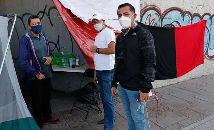 Los trabajadores colocaron  afuera de las instalaciones de la  empresa de comunicación  una enorme bandera con los colores  rojo y negro. Foto Vicente Juárez  