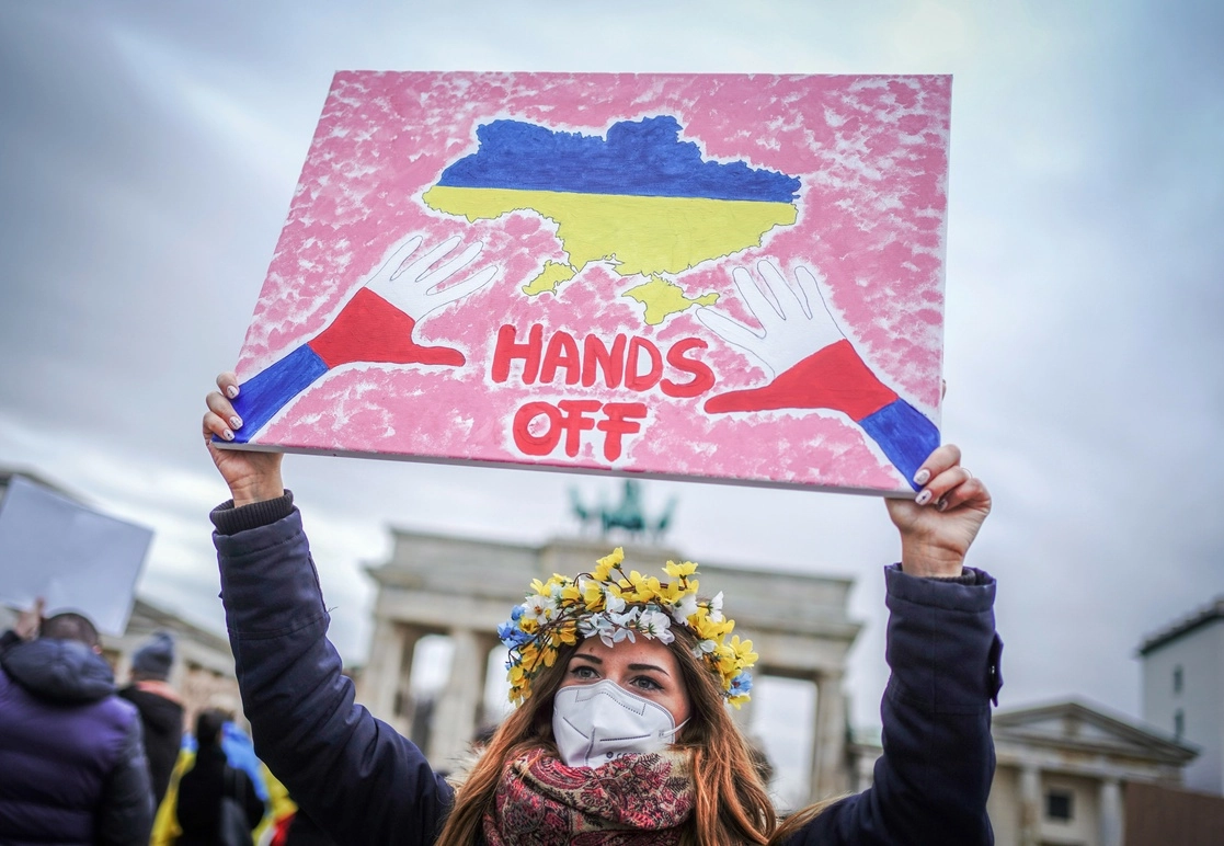Una mujer sostiene una pancarta durante una manifestación frente a la Puerta de Brandenburgo, en Berlín, Alemania, tras el ataque ruso a Ucrania, el 24 de febrero de 2022. Foto Ap