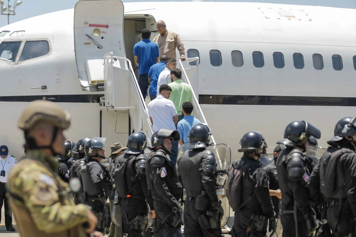 Migrantes venezolanos deportados y retenidos por EU en el Centro de Confinamiento del Terrorismo (Cecot) de El Salvador, abordan un avión en el Aeropuerto Internacional "San Oscar Arnulfo Romero y Galdámez" en el departamento de La Paz, el 18 de julio de 2025. Foto 

