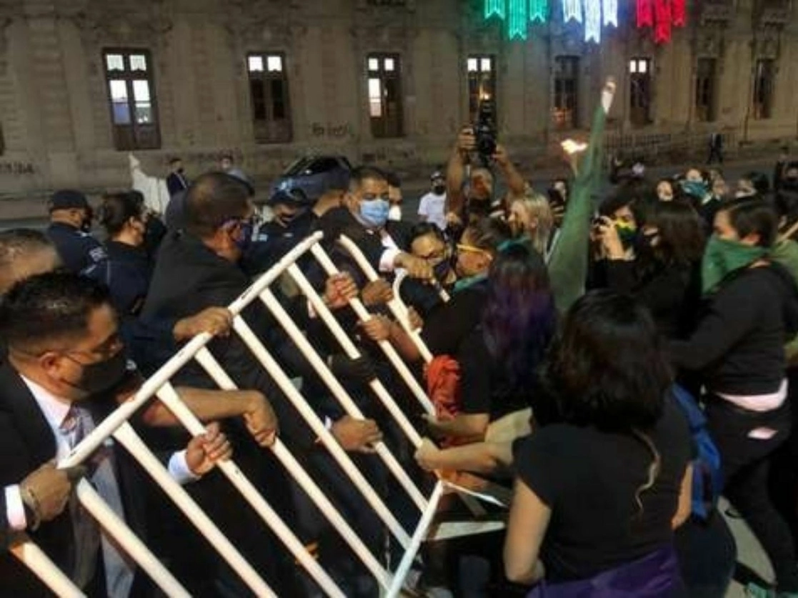 Activistas derribaron las vallas de seguridad para entrar a la plaza Hidalgo, frente al palacio de gobierno de Chihuahua, con el fin de interrumpir la ceremonia del Grito de Independencia que encabezó el gobernador Javier Corral. Foto cortesía La Opción de Chihuahua