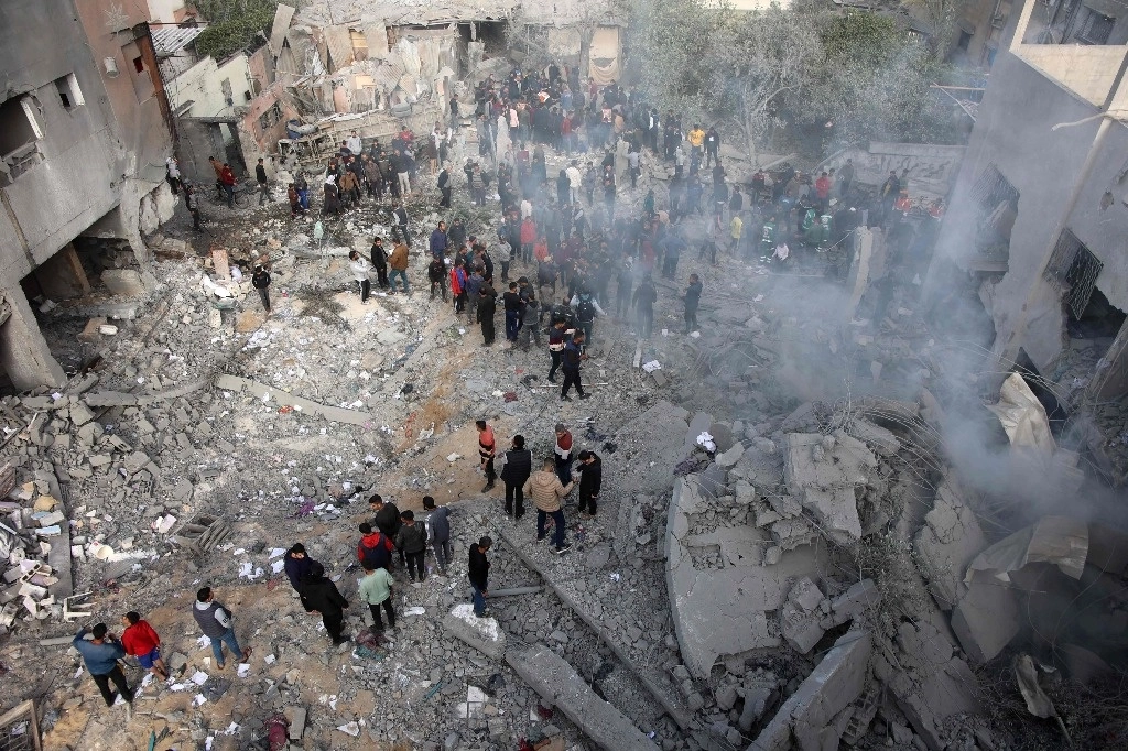 Palestinos se reúnen en el barrio de Tuffah, al este de la franja de Gaza, luego de un ataque aéreo israelí, el 26 de diciembre de 2024. Foto Afp