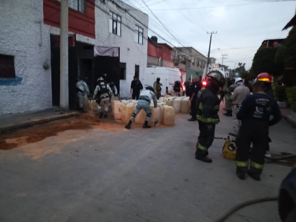  Elementos del Ejército, de la policía mexiquense y del municipio de Tlalnepantla, así como de Protección Civil y bomberos, decomisaron ayer decenas de bidones con gasolina en un domicilio de esa localidad, donde ayer ocurrió una fuga y derrame del hidrocarburo. Foto ‘La Jornada’